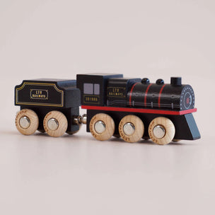 a black toy train with a plain background 