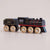 a black toy train with a plain background 