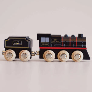 A wooden toy train set with a black locomotive and tender, featuring natural wood wheels and gold lettering that reads 'LTV RAILWAYS' and 'LEPOYVAN'.