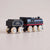 Wooden toy train engine with black and red design on a light gray background
