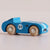 Blue toy car with wooden wheels on a light gray background