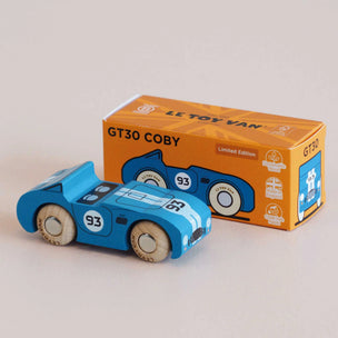 A blue wooden toy race car with the number 93, shown in front of its orange LL Toy Van GT30 Coby Limited Edition packaging box on a neutral beige background.