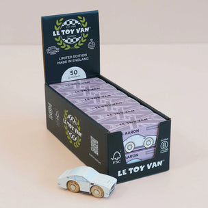 Le Toy Van toy car packaging with a toy car in front on a beige background
