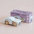 Wooden toy car modelled after a GT35 vehicle with packaging on a beige background