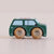 Wooden toy car with green body and brown wheels on a beige background