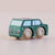 Green wooden toy car with brown wheels on a beige background