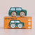 A wooden toy car named 'Molly' in green with light blue windows and natural wood wheels, displayed on top of its orange packaging box labeled 'GT45 MOLLY'.