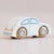A wooden toy car shaped like a classic Volkswagen Beetle, painted off-white with light blue window details and natural wood wheels branded 'LETOYVAN'.