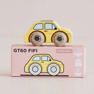 A yellow wooden toy car with wood-textured wheels sits on top of its pink retail box. The box is labeled 'GT60 FIFI' and 'Limited Edition' with small product icons on the right side.