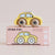 A yellow wooden toy car with wood-textured wheels sits on top of its pink retail box. The box is labeled 'GT60 FIFI' and 'Limited Edition' with small product icons on the right side.