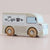 Wooden toy van with 'Café' and coffee cup design on a beige background