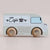 Toy cafe van with wooden wheels on a light background