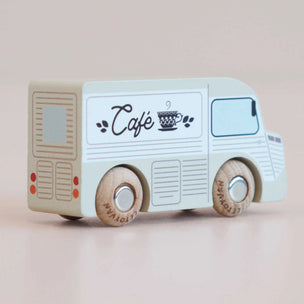 Toy cafe truck with 'Cafe' and coffee cup design on a beige background