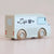 Toy cafe truck with 'Cafe' and coffee cup design on a beige background