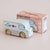 Wooden toy van with 'Cafe' design and packaging on a light pink background