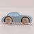 Toy car with wooden wheels on a light beige background
