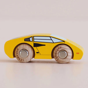 wooden yellow toy car on grey back ground 