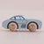 Toy car with wooden wheels on a beige background