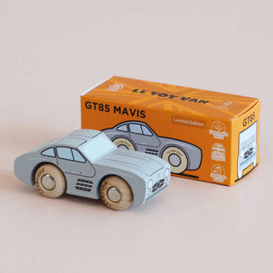 Wooden toy car and its packaging with 'Le Toy Van' branding on a beige background