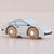 A handcrafted wooden toy car designed like a sports coupe, featuring a white-painted body and natural wood wheels with silver metal hubs. The brand name 'LE TOY' is engraved on the wood of the wheels.