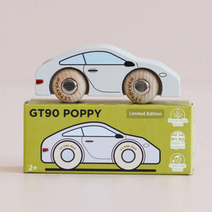 A wooden toy car with light wood wheels sits on top of its lime green product box, which is labeled 'GT90 POPPY' and shows a side illustration of the car.