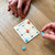 Game of Nine Holes being played on a wooden table.
