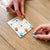 Game of Nine Holes being played on a wooden table.