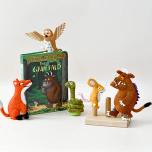 Toy figures of characters from 'The Gruffalo' book on a white background
