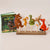 Set of Gruffalo plush toys on sticks with a book titled 'The Gruffalo' on a beige background