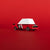 Toy car with a white roof and red body on a red background