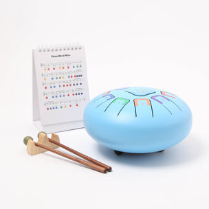 Tambu percussion instrument in light blue with music and sticks