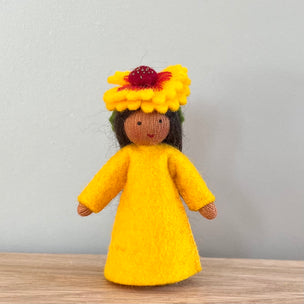 A felt Firewheel Flower Fairy wearing a golden yellow dress and firewheel flower on her head with medium skin tone | © Conscious Craft