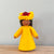 A felt Firewheel Flower Fairy wearing a golden yellow dress and firewheel flower on her head with medium skin tone | © Conscious Craft