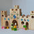 Wooden block castle with colorful gemstones on a gray background