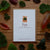 Card with 'Ivy' design on a wooden surface with leaves