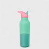 Green water bottle with pink spout on a light gray background