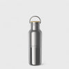 Silver water bottle with a gold cap on a light gray background