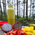 Fruit platter with dragon fruit, strawberries, and mangoes on a wooden board with a yellow water bottle in the background.