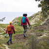 two people hiking with water bottles