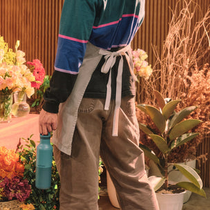 Person holding a bouquet of flowers in a floral setting