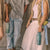 Four people walking together, each carrying different items like a red bag, green water bottle, and white shoes.