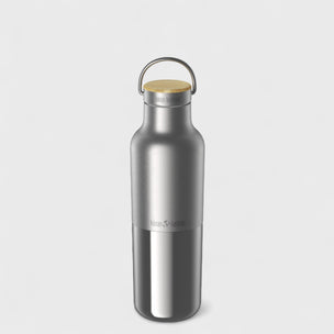 Silver water bottle with a wooden cap on a light gray background