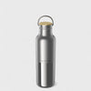 Silver water bottle with a wooden cap on a light gray background