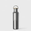 Silver water bottle with a wooden cap on a light gray background
