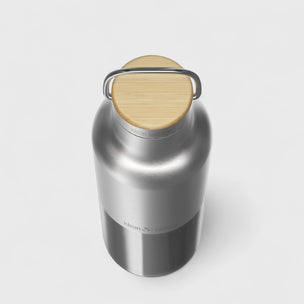 Silver thermos with a wooden lid on a white background