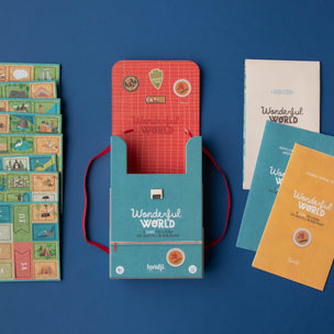 Collection of 'Wonderful World' themed products including a box, cards, and a book on a blue background.