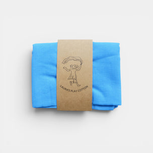 Blue fabric folded and tied with a brown paper strap on a white background