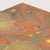 Textured surface with orange and green patterns