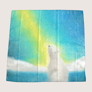Fleece blanket with a polar bear and aurora borealis design