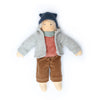 Doll wearing a gray coat, red shirt, brown pants, and blue hat on a white background